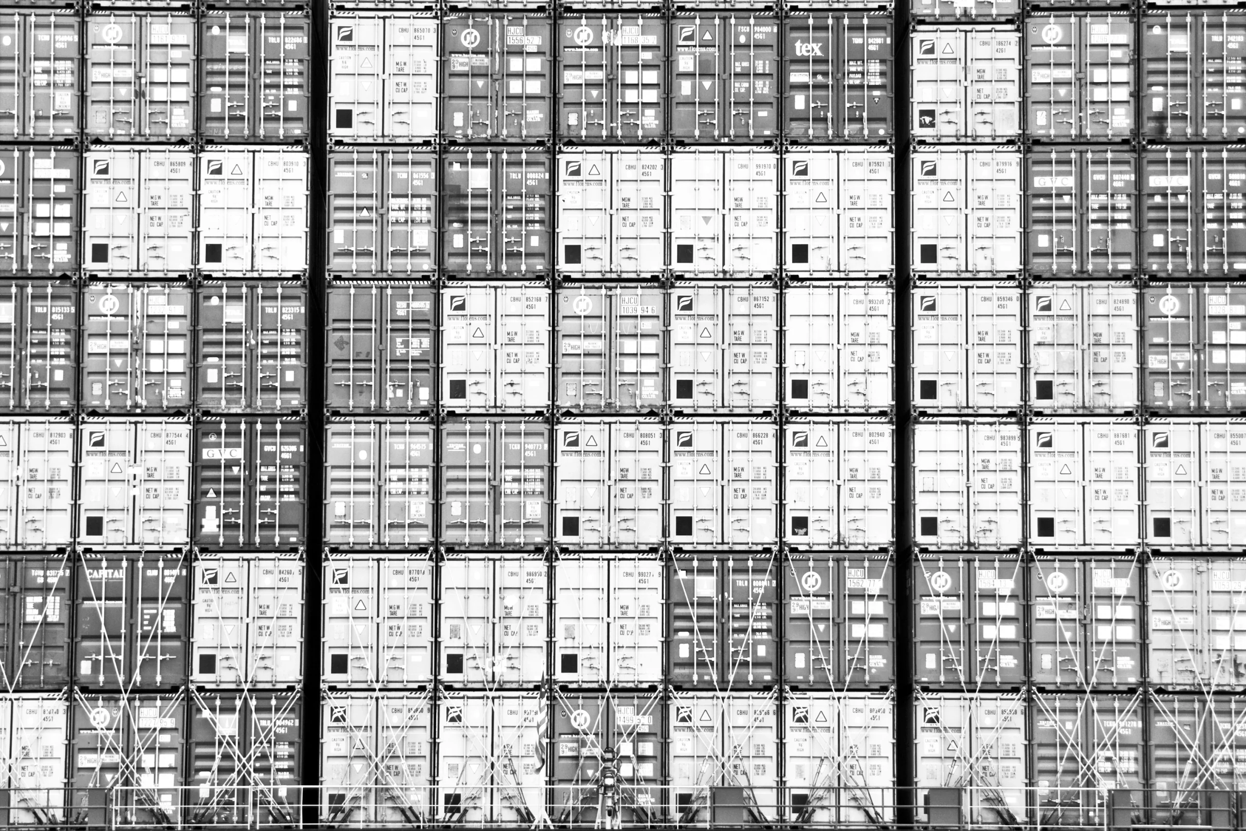 Foto in schwarz weiß von gestapelten Containern, Foto: Thomas, stock.adobe.com